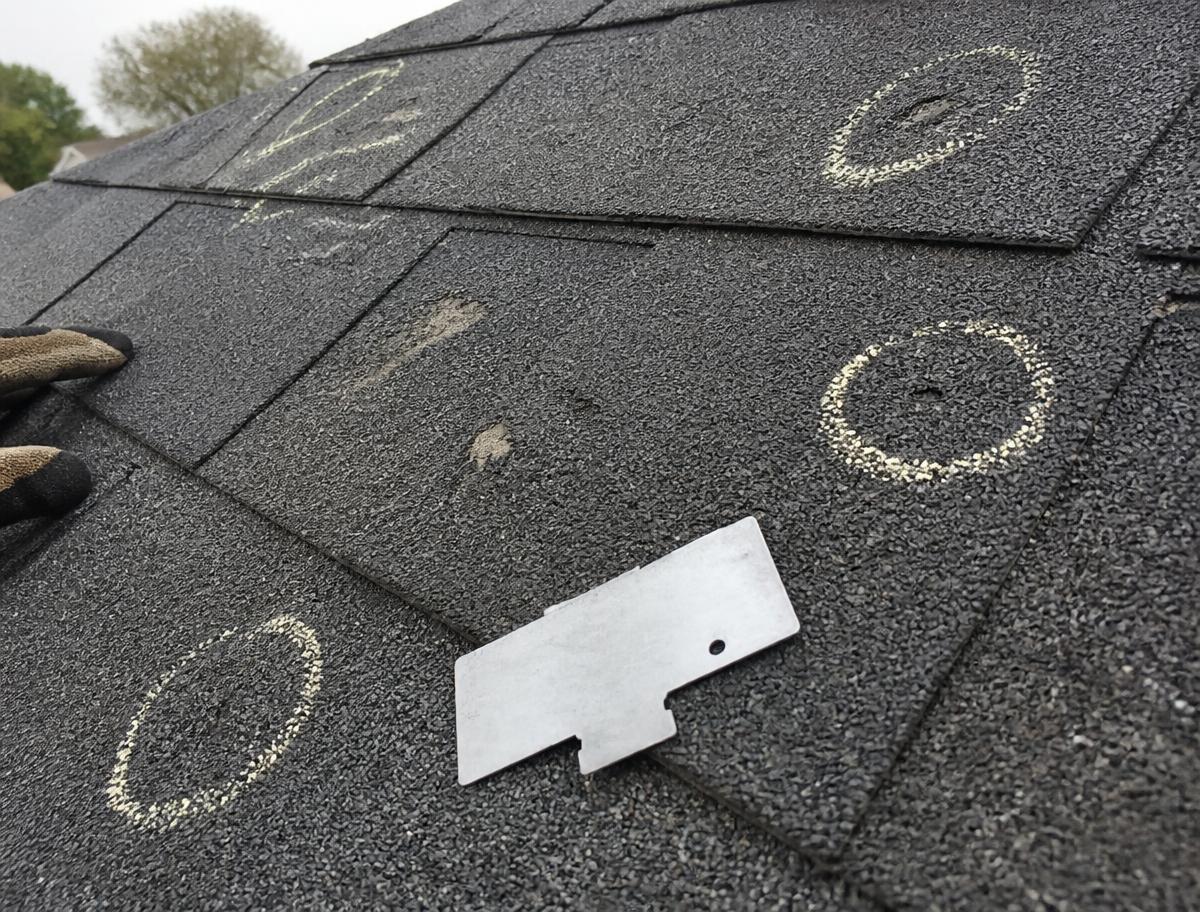 Hail damage marked with chalk during a roof inspection